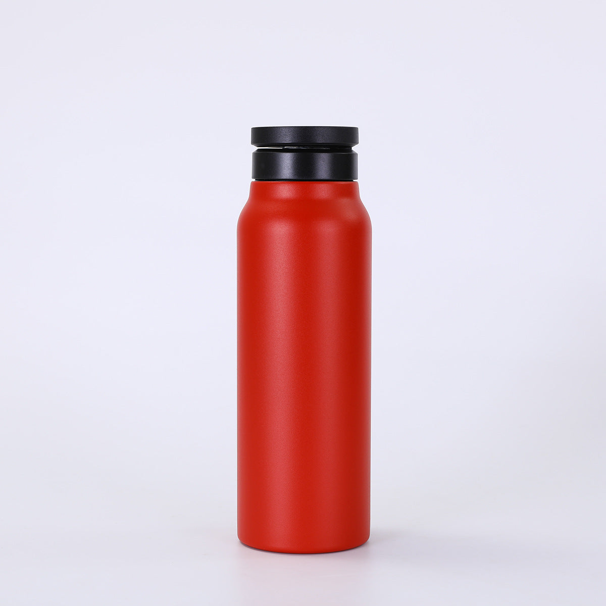 Red water bottle with a black lid on a white background