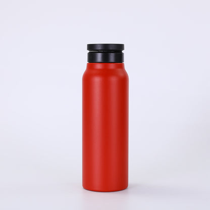 Red water bottle with a black lid on a white background